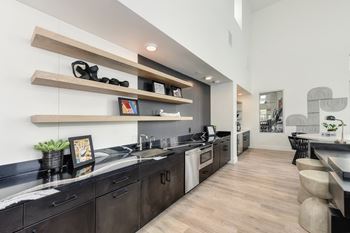 Clubhouse with black countertop, hardwood inspired floor